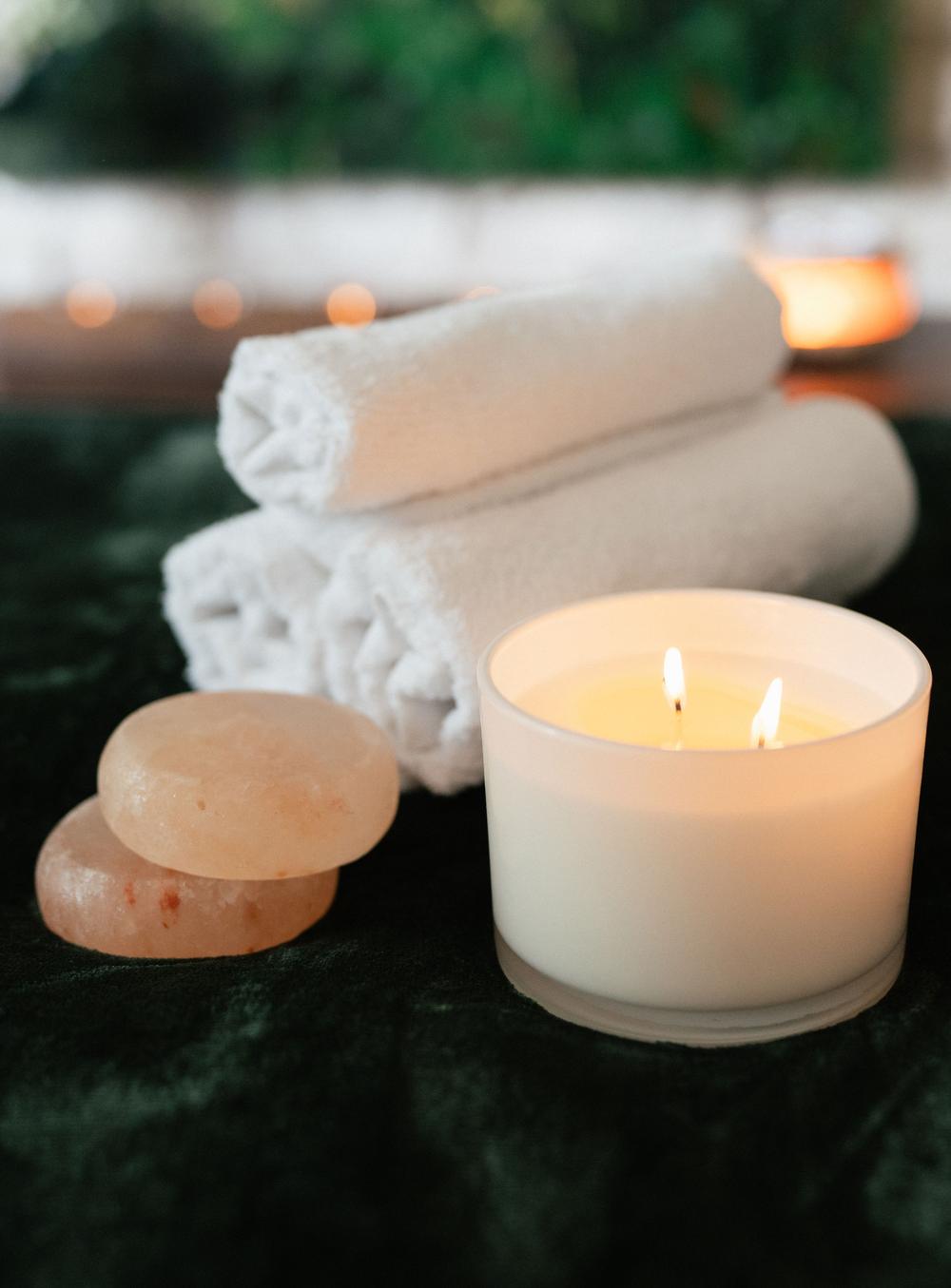 Green and gold art, candlelight and stone wall inside W Spa